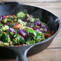 cast iron skillet of stir fry vegetables