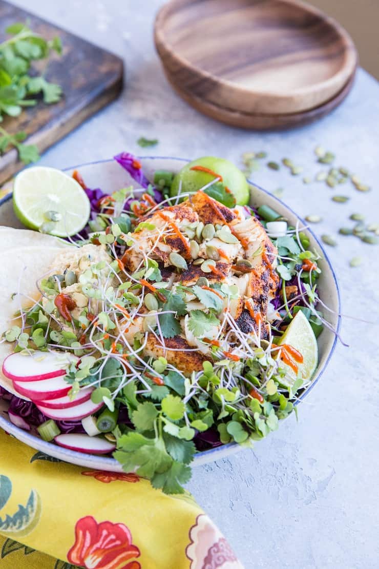 Baja Fish Taco Bowl with spicy halibut, avocado crema, and red cabbage makes for a fresh and vibrant meal