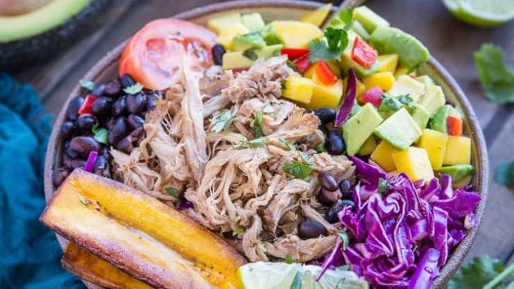 Crock Pot Carnitas Burrito Bowls with mango salsa, black beans, fried plantains, and shredded cabbage