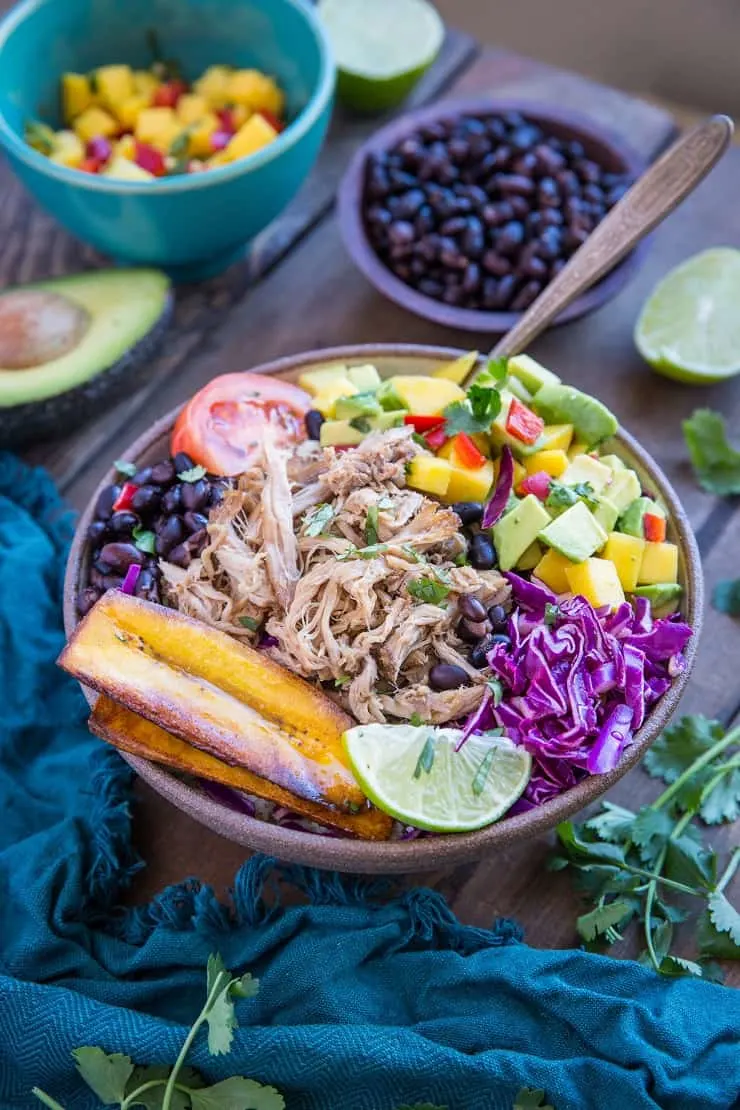 Crock Pot Carnitas Burrito Bowls with mango salsa, black beans, fried plantains, and shredded cabbage
