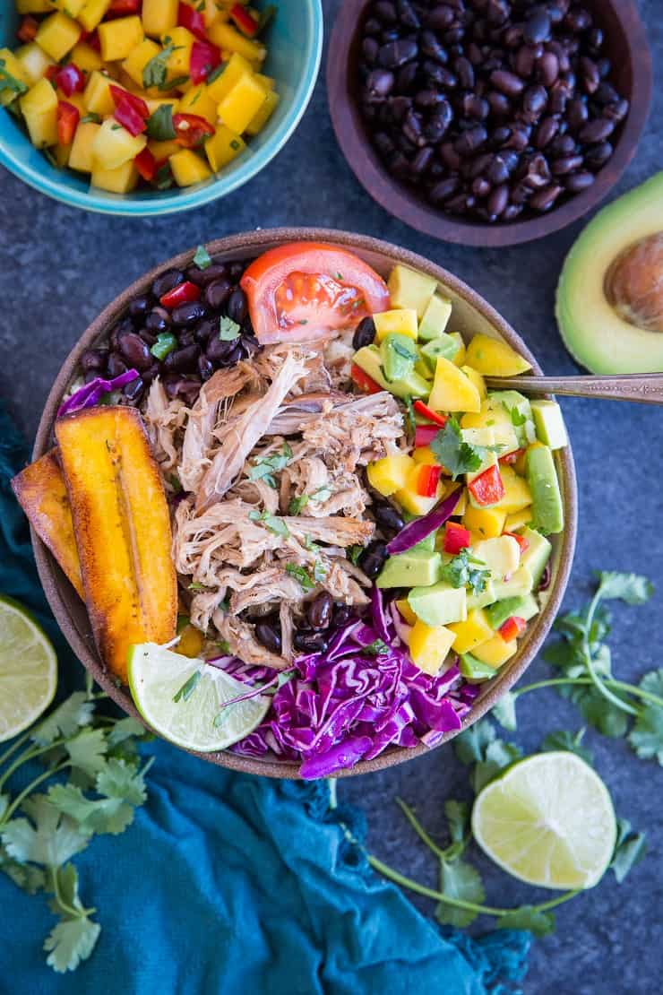 Crock Pot Carnitas Burrito Bowls with black beans, mango salsa, plantains, and cabbage. A healthy and delicious dinner recipe
