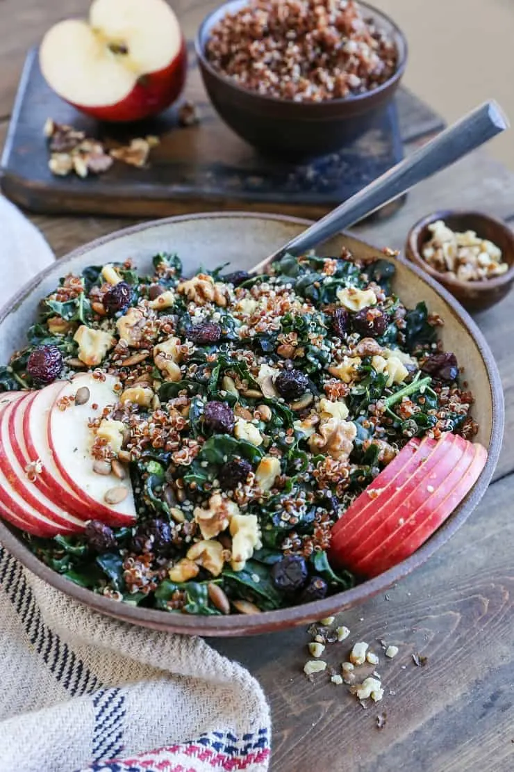 Hormone-Supporting Kale and Quinoa Salad with pumpkin seeds, walnuts, apple, and dried cranberries. A superfood crunchy salad recipe.