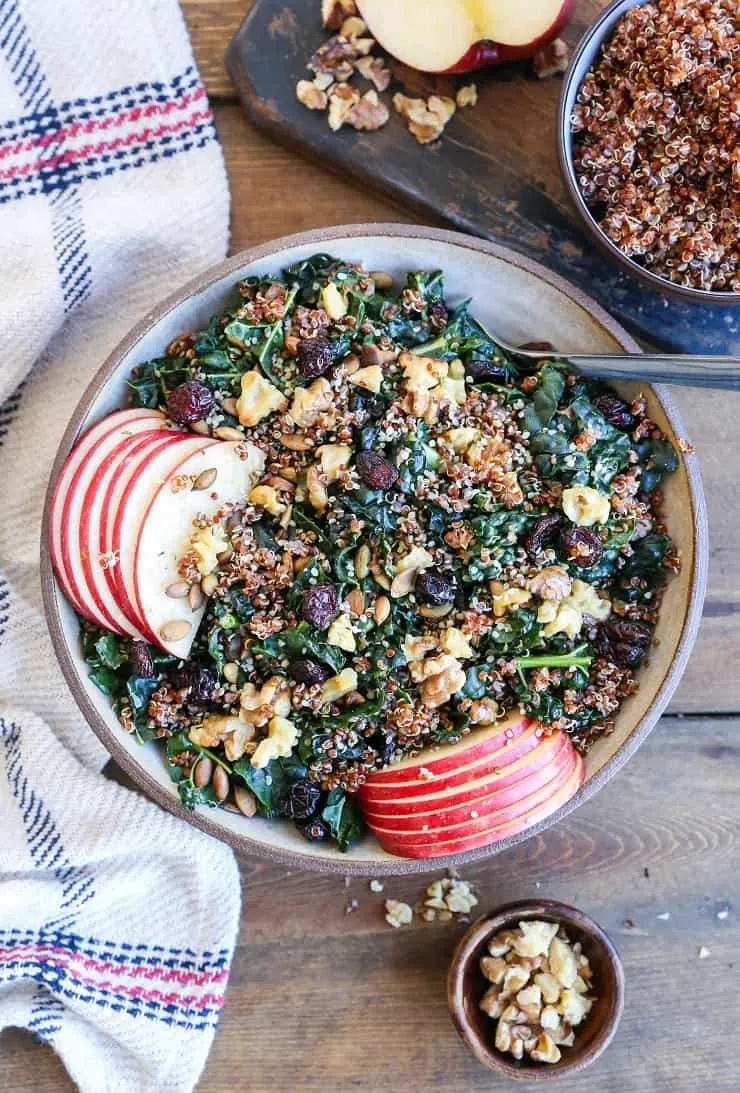 Hormone-Supporting Kale and Quinoa Salad with apple, dried cranberries, pumpkin seeds, and walnuts. A superfood crunchy salad perfect for making throughout the week