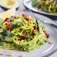 Avocado Pesto Zoodles with Sun-Dried Tomatoes, Spinach, and pine nuts. These creamy zucchini noodles are vegan, paleo, healthy, and super easy to make