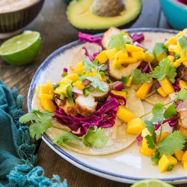 Grilled Chicken Tacos with Mango Salsa, cabbage slaw, and chipotle sour cream - a fresh, vibrant, and unique take on tacos!