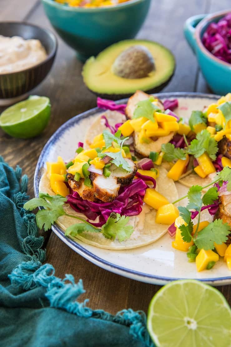 Grilled Chicken Tacos with Mango Salsa, cabbage slaw, and chipotle sour cream - a fresh, vibrant, and unique take on tacos!