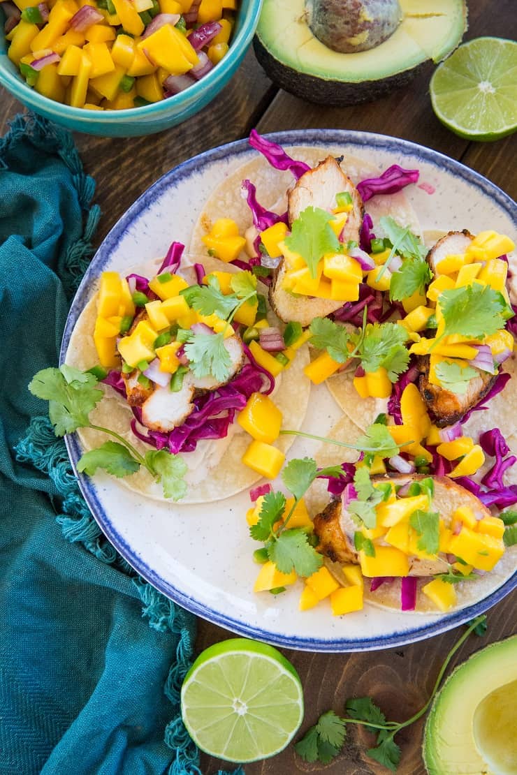 Grilled Chicken Tacos with Mango Salsa, cabbage slaw, and chipotle sour cream - a fresh, vibrant, and unique take on tacos!