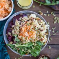 Gut Healthy Probiotic Power Bowls with roasted beets, cauliflower, dandelion greens, brown rice, sauerkraut, and orange dressing. These nutrient-rich bowls are amazing for maintaining a healthy gut.