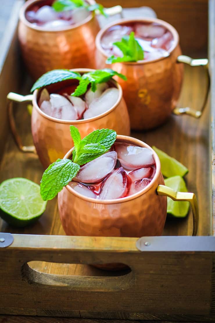 Strawberry Moscow Mules - a lower sugar Moscow Mule recipe with homemade strawberry simple syrup for a skinny cocktail