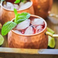 Strawberry Moscow Mules - a lower sugar Moscow Mule recipe with homemade strawberry simple syrup for a skinny cocktail