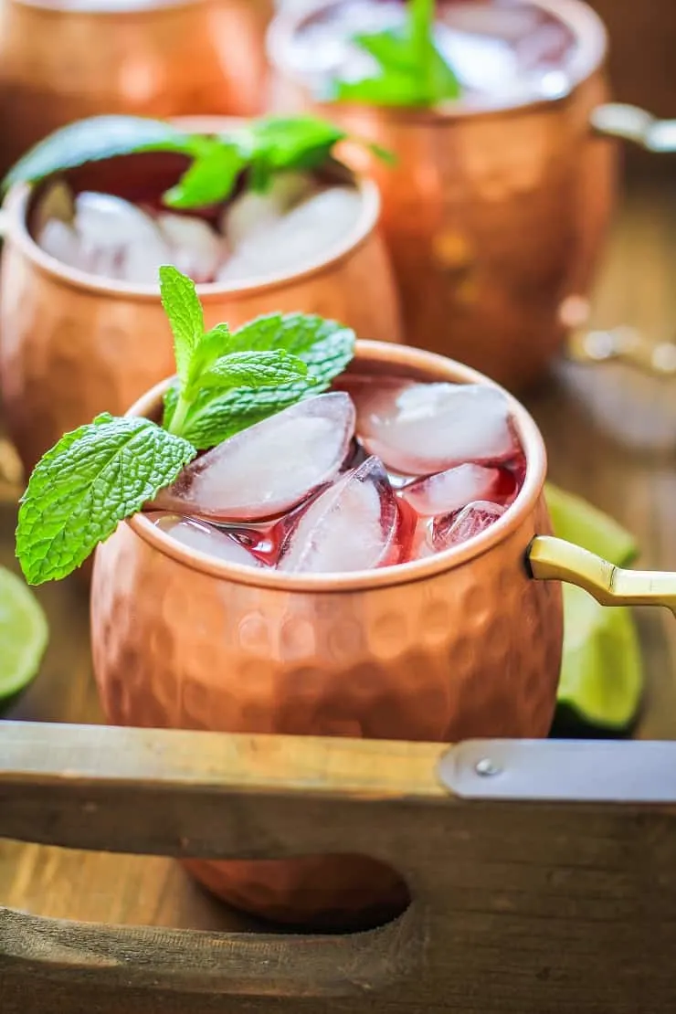 Strawberry Moscow Mules - a lower sugar Moscow Mule recipe with homemade strawberry simple syrup for a skinny cocktail