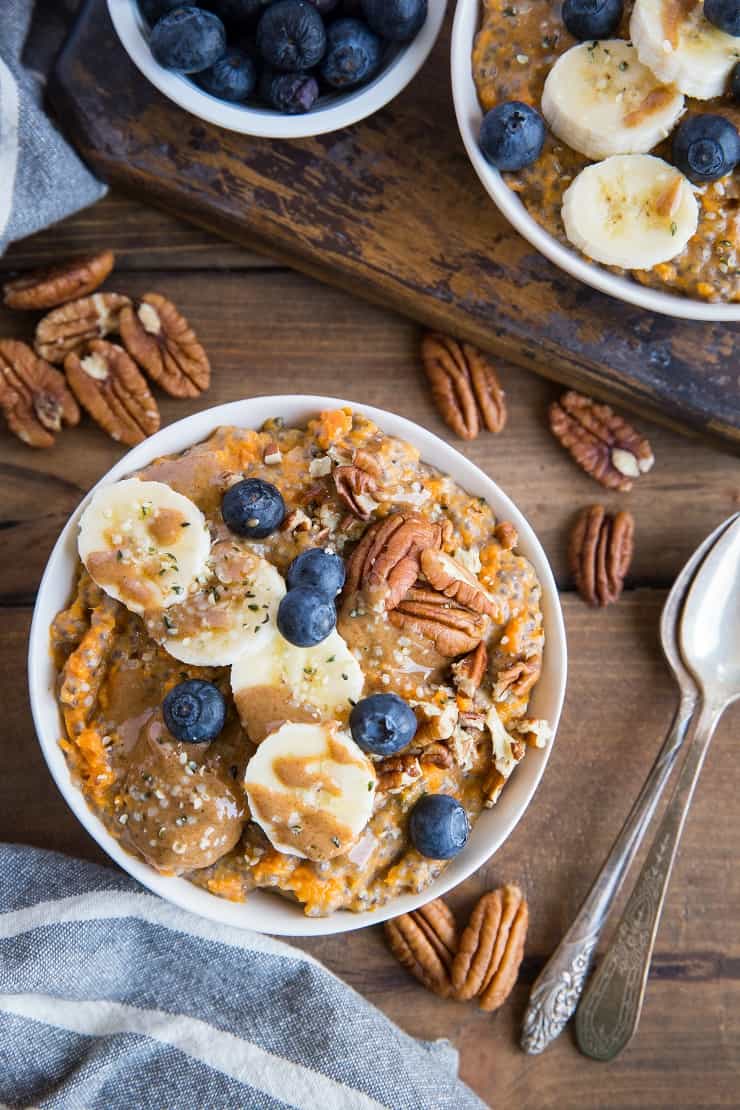 Sweet Potato Porridge with chia seeds, almond milk, pure maple syrup, banana, blueberries, pecans, and almond butter. A nutritious breakfast, snack or dessert!