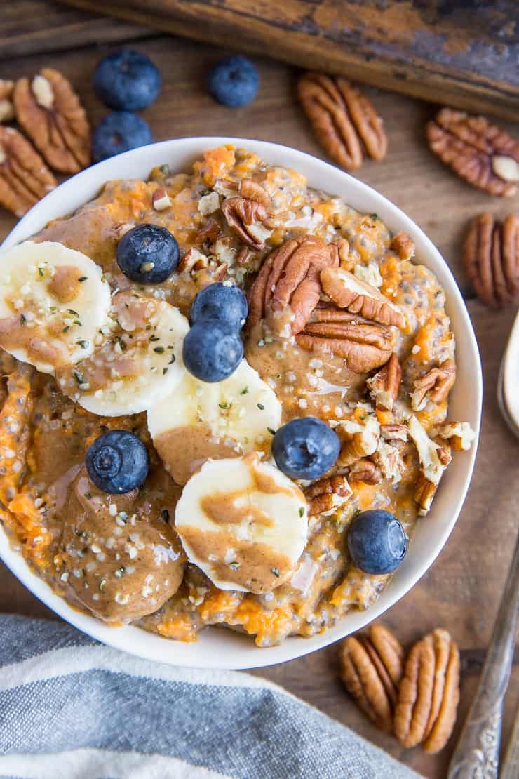 Sweet Potato Porridge with chia seeds, almond milk, pure maple syrup, banana, blueberries, pecans, and almond butter. A nutritious breakfast, snack or dessert!