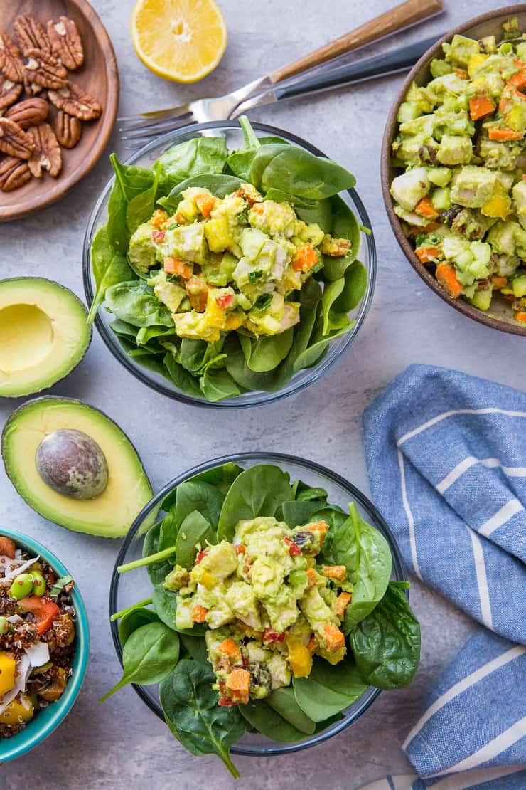 Mayo-Free Mango Avocado Chicken Salad - a healthier chicken salad recipe with carrots, cucumber, green onion, bell pepper, raisins, and pecans. Serve it up on toasted bread as a sandwich or on a green salad!