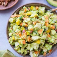 Mayo-Free Mango Avocado Chicken Salad - a healthier chicken salad recipe with carrots, cucumber, green onion, bell pepper, raisins, and pecans. Serve it up on toasted bread as a sandwich or on a green salad!