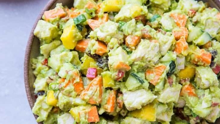 Mayo-Free Mango Avocado Chicken Salad - a healthier chicken salad recipe with carrots, cucumber, green onion, bell pepper, raisins, and pecans. Serve it up on toasted bread as a sandwich or on a green salad!