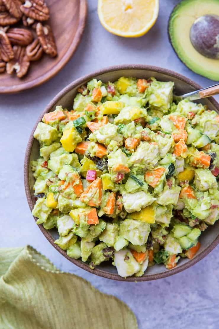 Mayo-Free Mango Avocado Chicken Salad - a healthier chicken salad recipe with carrots, cucumber, green onion, bell pepper, raisins, and pecans. Serve it up on toasted bread as a sandwich or on a green salad!