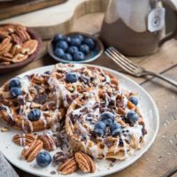 Paleo Chocolate Pecan Waffles with almond butter, coconut butter, and blueberries. This grain-free waffle recipe is prepared in your blender and tastes magnificent!