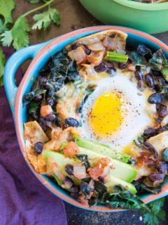 Baked Huevos Rancheros - a unique spin on the traditional Mexican breakfast with black beans, corn tortillas, salsa, avocado, kale, and cheese