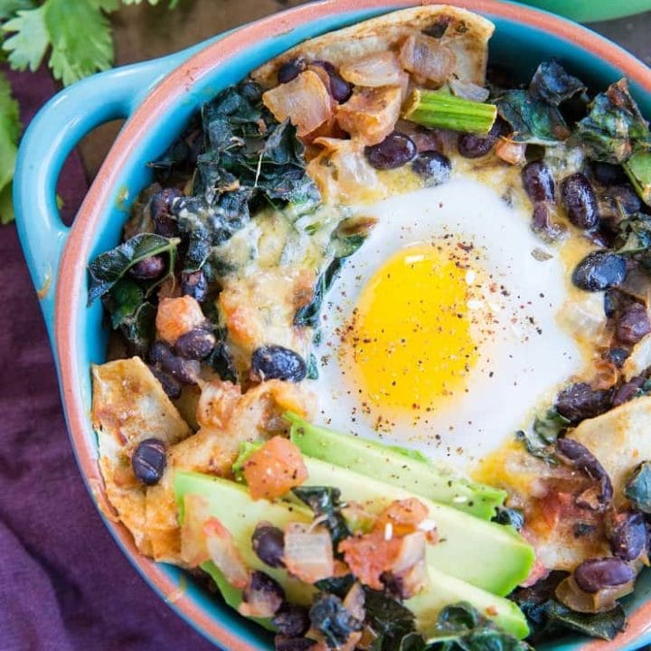 Baked Huevos Rancheros - a unique spin on the traditional Mexican breakfast with black beans, corn tortillas, salsa, avocado, kale, and cheese