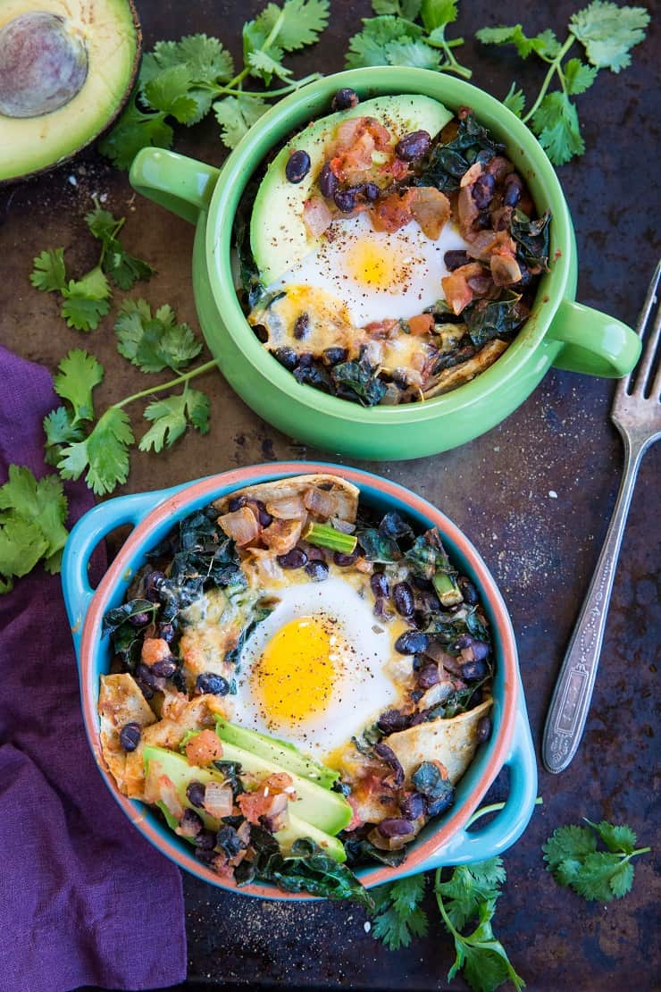 Baked Huevos Rancheros - a unique spin on the traditional Mexican breakfast with black beans, corn tortillas, salsa, avocado, kale, and cheese