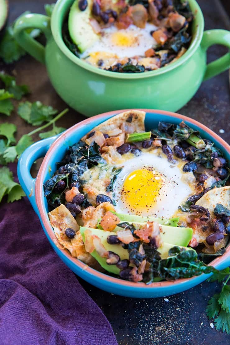 Baked Huevos Rancheros - a unique spin on the traditional Mexican breakfast with black beans, corn tortillas, salsa, avocado, kale, and cheese