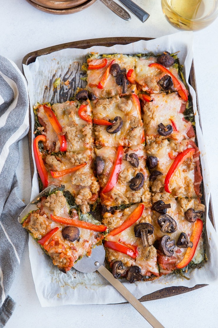 Keto Pizza with Sausage, Mushrooms, Sun-Dried Tomatoes, and Garlic on a kale pizza crust. I know...CRAZY!