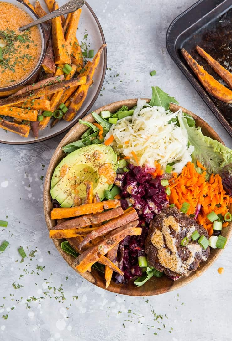 Burger Bowls with Chipotle Sauce, sauerkraut, pickled beets, carrots, mixed greens and avocado - a nutritious approach to hamburgers! These bowls are a healthy dinner option and are easy to make any night of the week!