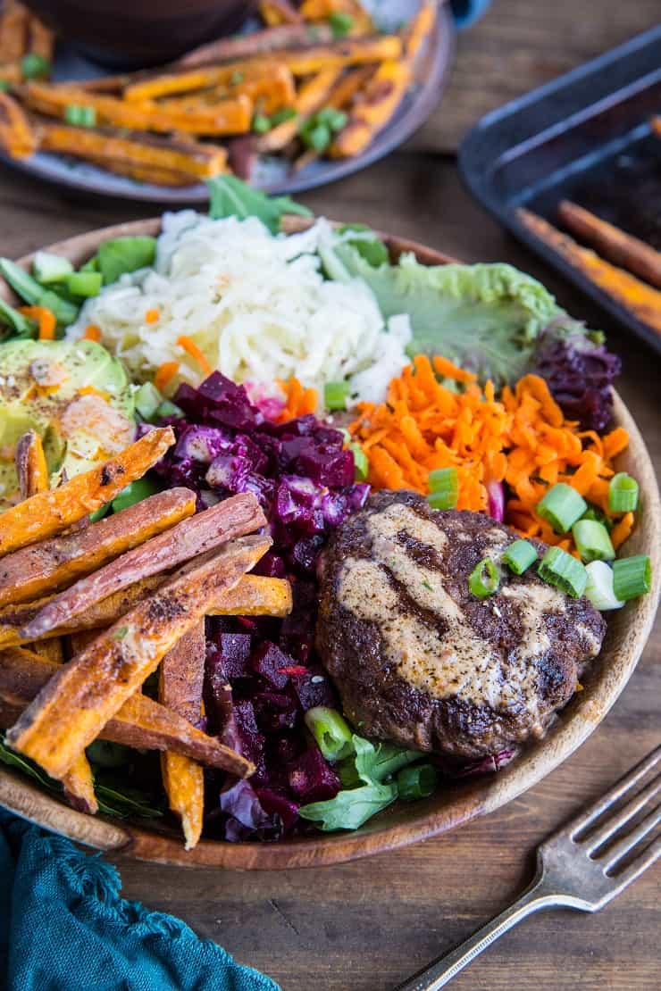 Burger Bowls with Chipotle Sauce, sauerkraut, pickled beets, carrots, mixed greens and avocado - a nutritious approach to hamburgers! These bowls are a healthy dinner option and are easy to make any night of the week!