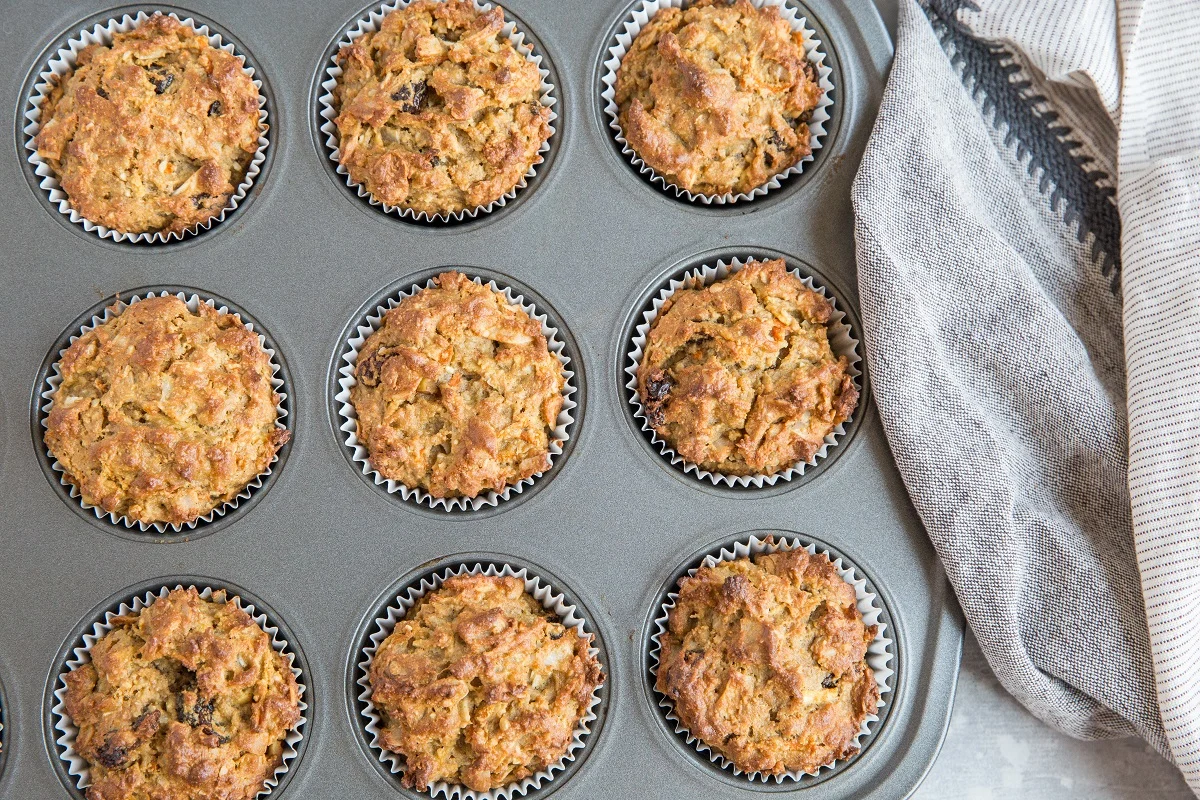 Finished paleo morning glory muffins fresh out of the oven in a muffin tray.