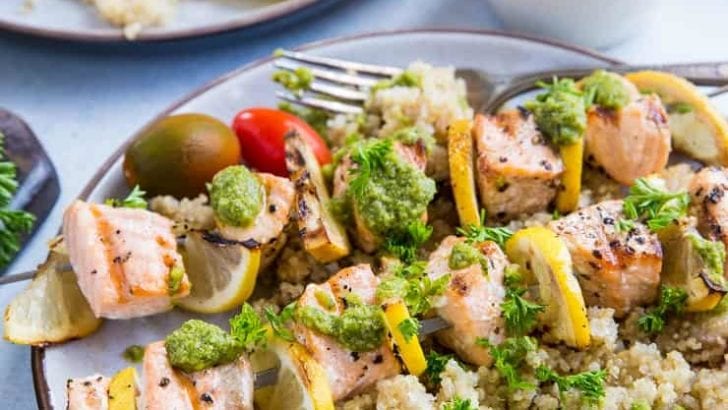 Grilled Salmon Kabobs with pesto sauce and quinoa - a quick, easy, nutritious meal | TheRoastedRoot.com #glutenfree #paleo #primal #healthy