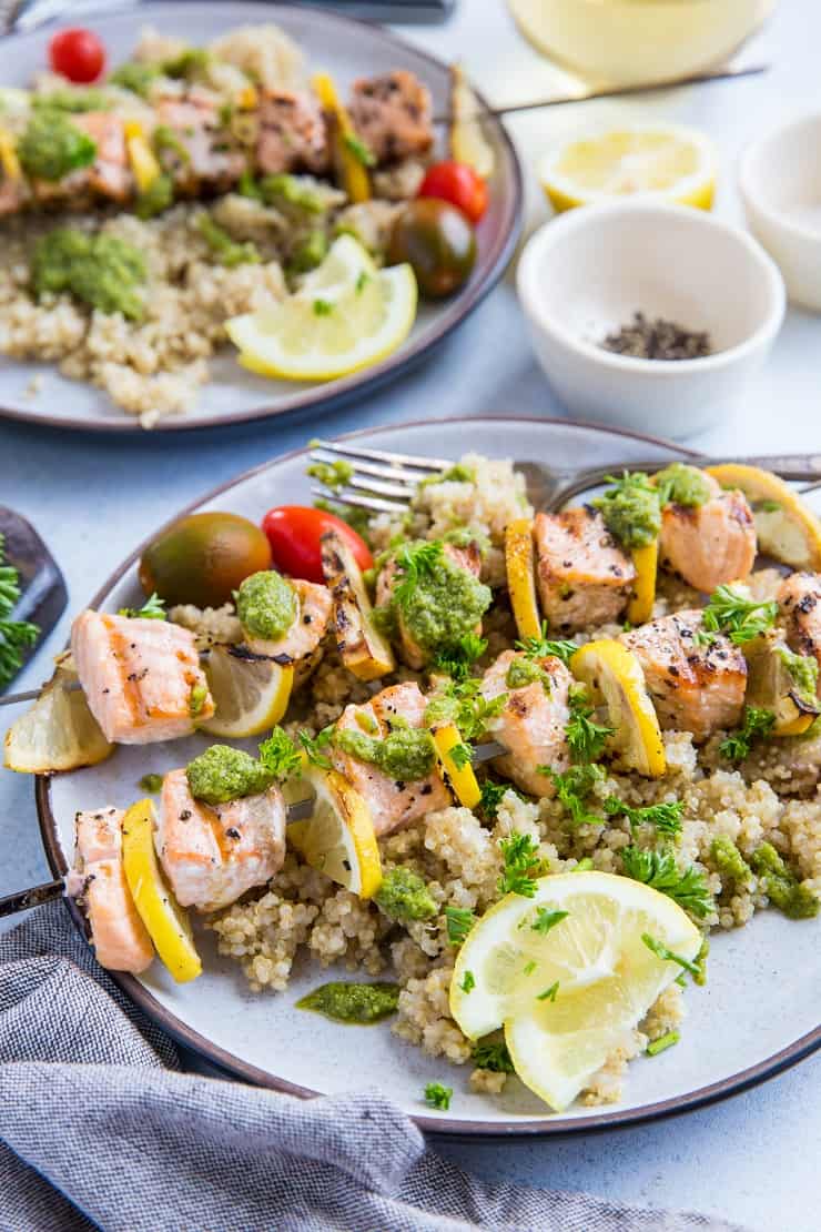 Grilled Salmon Kabobs with pesto sauce and quinoa - a quick, easy, nutritious meal | TheRoastedRoot.com #glutenfree #paleo #primal #healthy