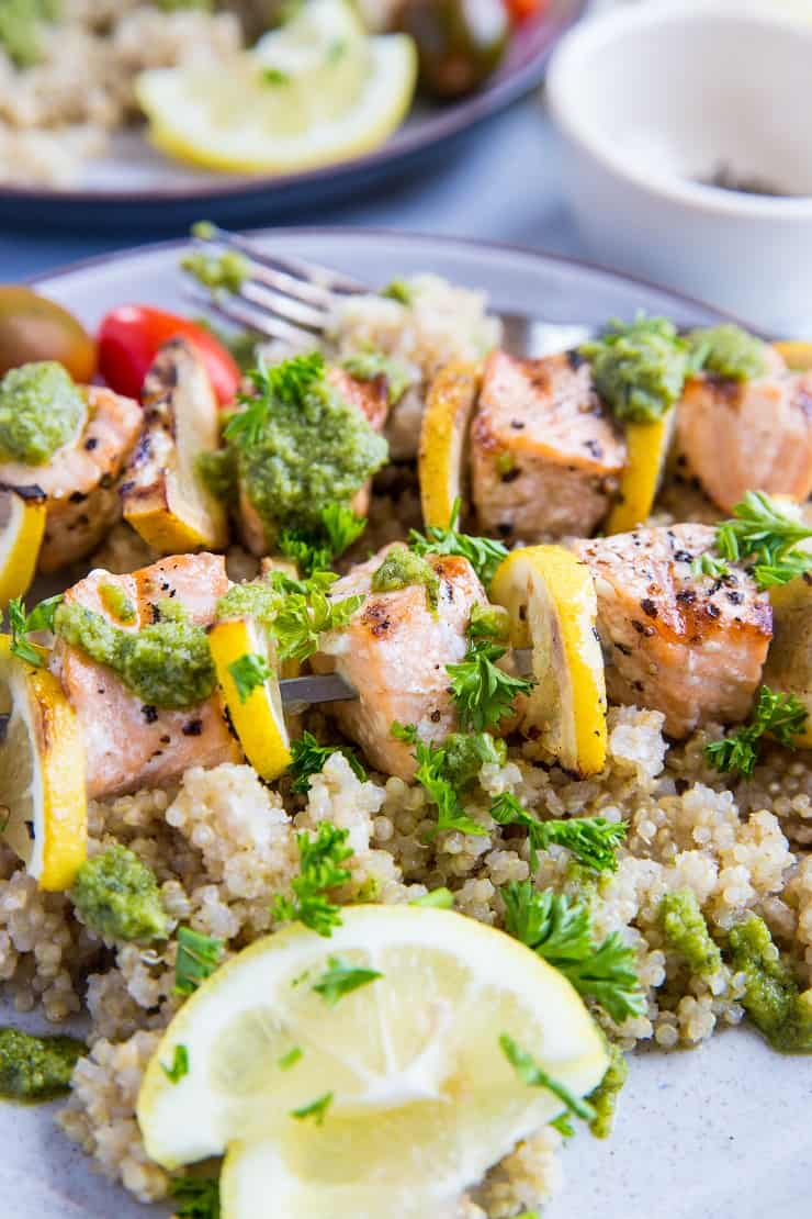 Grilled Salmon Kabobs with pesto sauce and quinoa - a quick, easy, nutritious meal | TheRoastedRoot.com #glutenfree #paleo #primal #healthy