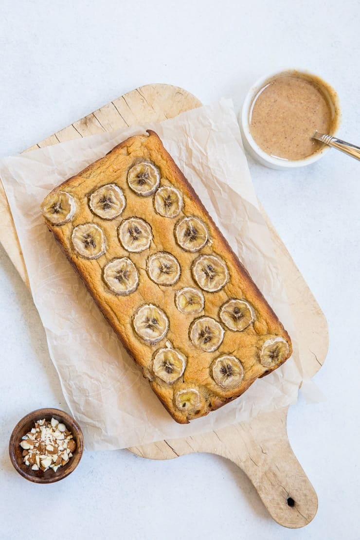 Paleo Banana Bread with Almond Butter Glaze - a deliciously moist and fluffy grain-free banana bread recipe that is dairy-free and refined sugar-free. The almond butter glaze is sinfully delicious | TheRoastedRoot.com
