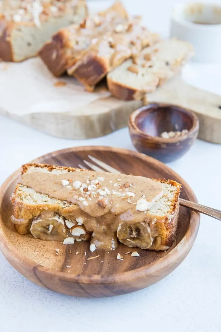 Paleo Banana Bread with Almond Butter Glaze - a deliciously moist and fluffy grain-free banana bread recipe that is dairy-free and refined sugar-free. The almond butter glaze is sinfully delicious | TheRoastedRoot.con