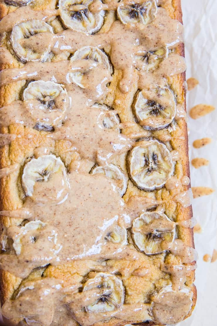 Paleo Banana Bread with Almond Butter Glaze - a deliciously moist and fluffy grain-free banana bread recipe that is dairy-free and refined sugar-free. The almond butter glaze is sinfully delicious | TheRoastedRoot.com