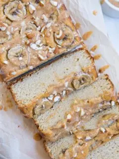 Paleo Banana Bread with Almond Butter Glaze - a deliciously moist and fluffy grain-free banana bread recipe that is dairy-free and refined sugar-free. The almond butter glaze is a MUST!