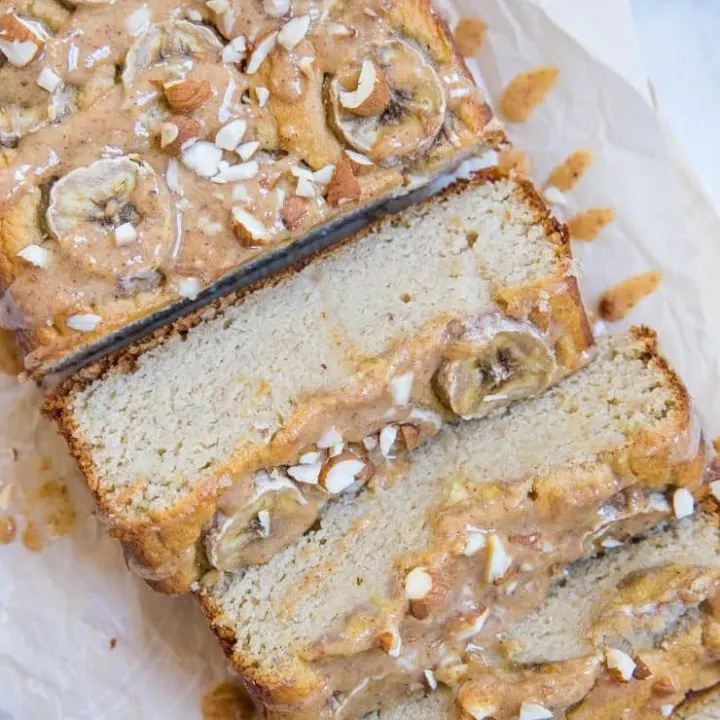 Paleo Banana Bread with Almond Butter Glaze - a deliciously moist and fluffy grain-free banana bread recipe that is dairy-free and refined sugar-free. The almond butter glaze is a MUST!