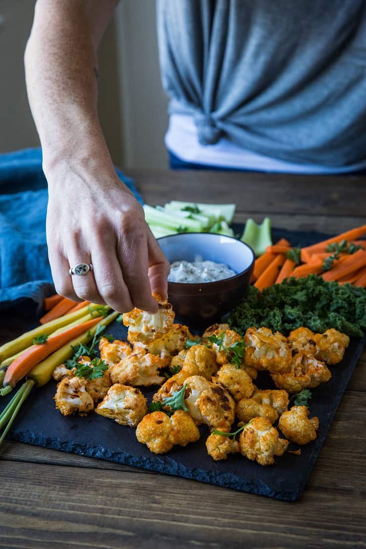 Buffalo Cauliflower Bites - a vegetarian version of buffalo wings made paleo, keto, low-carb, and whole30. A great appetizer for football season! | TheRoastedRoot.net #glutenfree #ketorecipe