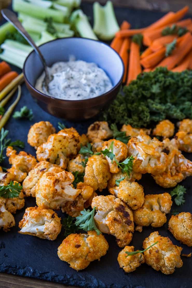 Buffalo Cauliflower Bites - a vegetarian version of buffalo wings made paleo, keto, low-carb, and whole30. A great appetizer for football season! | TheRoastedRoot.net #glutenfree #ketorecipe