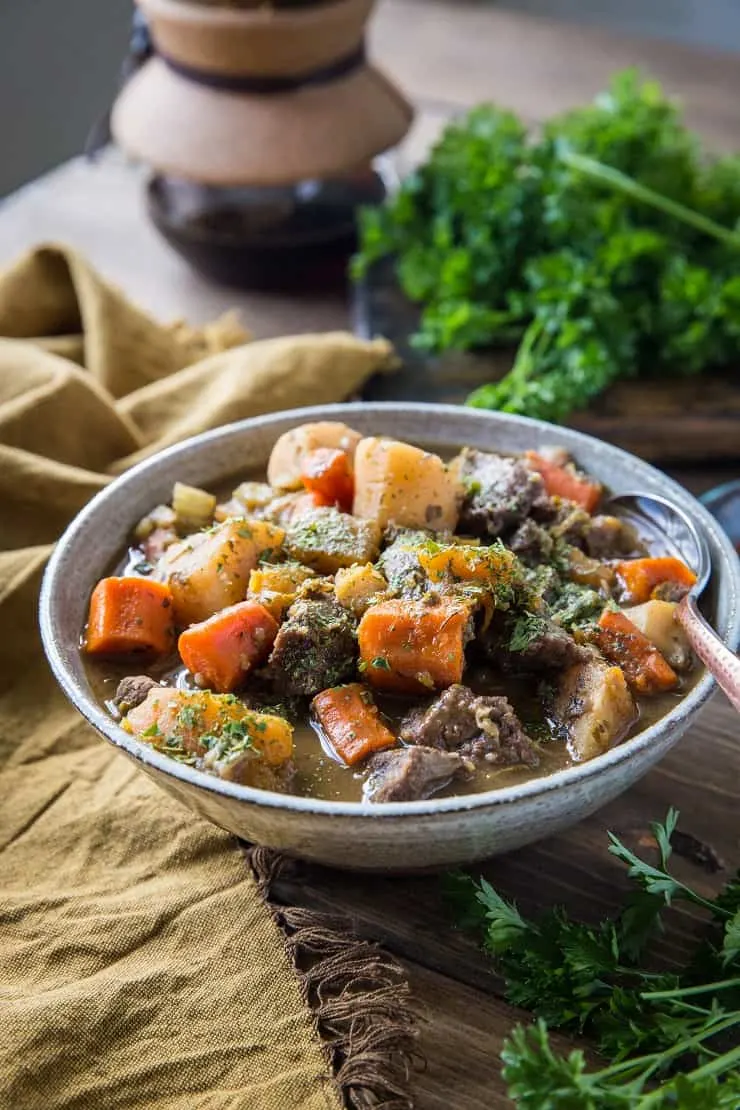 Paleo Instant Pot Beef Stew with parsnips, carrots, butternut squash. A potato-free stew recipe that is paleo, whole30, and AIP-friendly | TheRoastedRoot.net #glutenfree