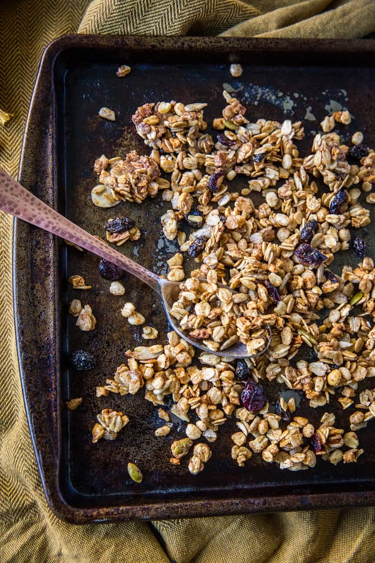 Gluten-Free Pumpkin Spice Granola with real pumpkin puree, pure maple syrup, nuts, and seeds. A marvelous fall and winter breakfast or snack | TheRoastedRoot.net #healthy #breakfast #recipe