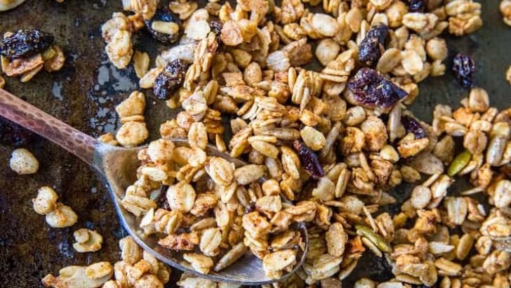 Gluten-Free Pumpkin Spice Granola with real pumpkin puree, pure maple syrup, nuts, and seeds. A marvelous fall and winter breakfast or snack | TheRoastedRoot.net #healthy #breakfast #recipe