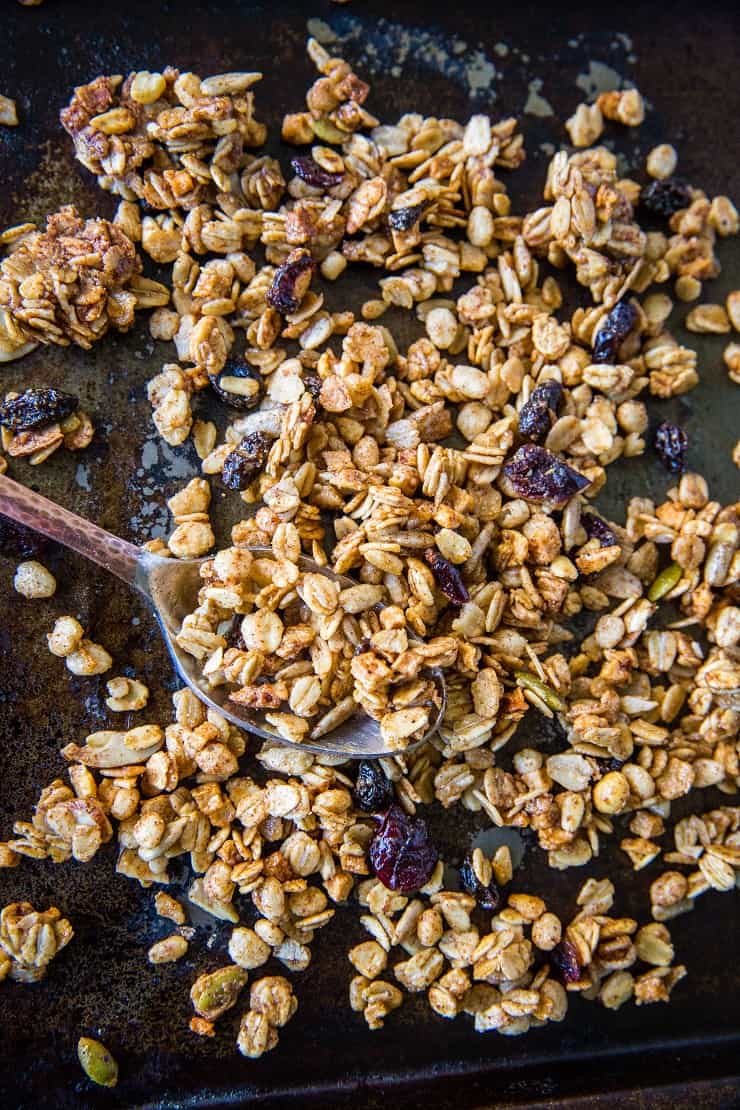 Gluten-Free Pumpkin Spice Granola with real pumpkin puree, pure maple syrup, nuts, and seeds. A marvelous fall and winter breakfast or snack | TheRoastedRoot.net #healthy #breakfast #recipe