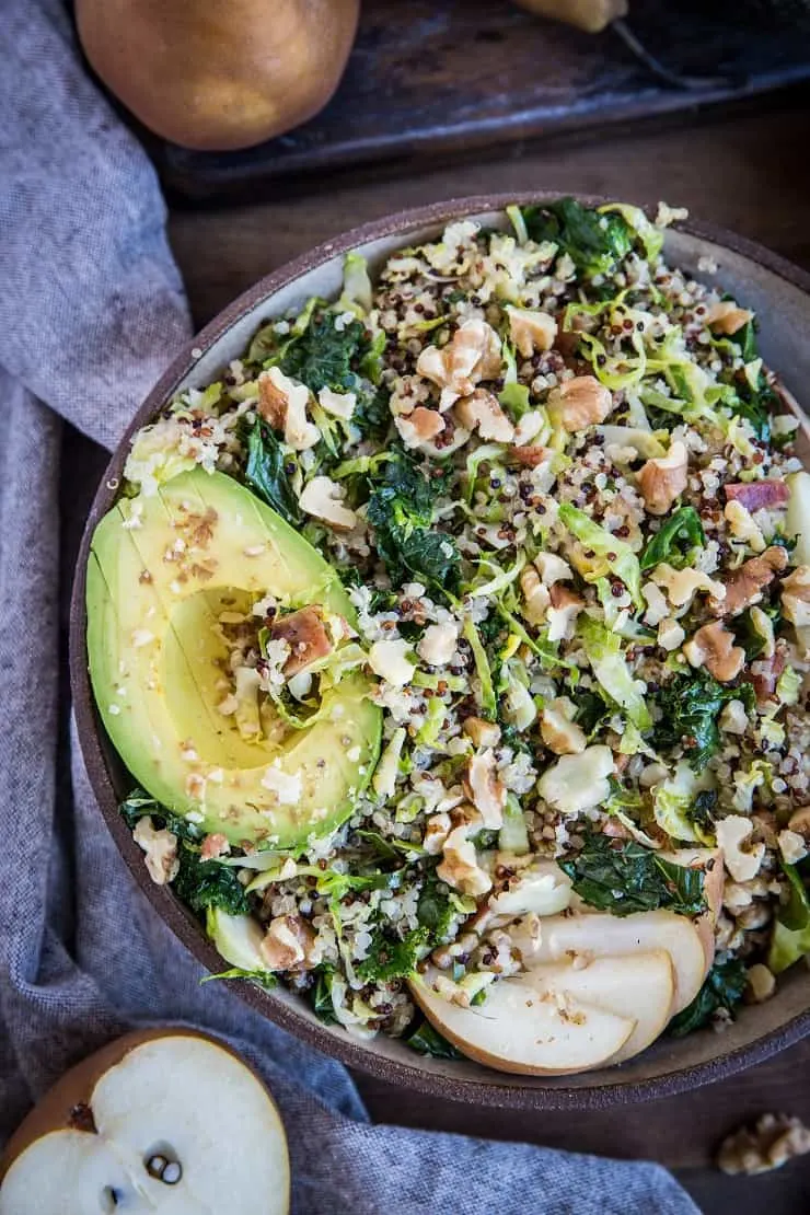 Warm Brussles Sprouts Salad with Kale, Quinoa, Pears, and Bacon Vinaigrette - an incredibly nutritious salad or side dish to share with friends and family | TheRoastedRoot.com #glutenfree #healthyrecipe