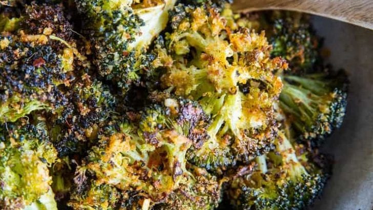 "Cheesy" Vegan Crispy Broccoli - an easy dairy-free roasted broccoli recipe that has a lovely cheesy flavor from nutritional yeast | TheRoastedRoot.com