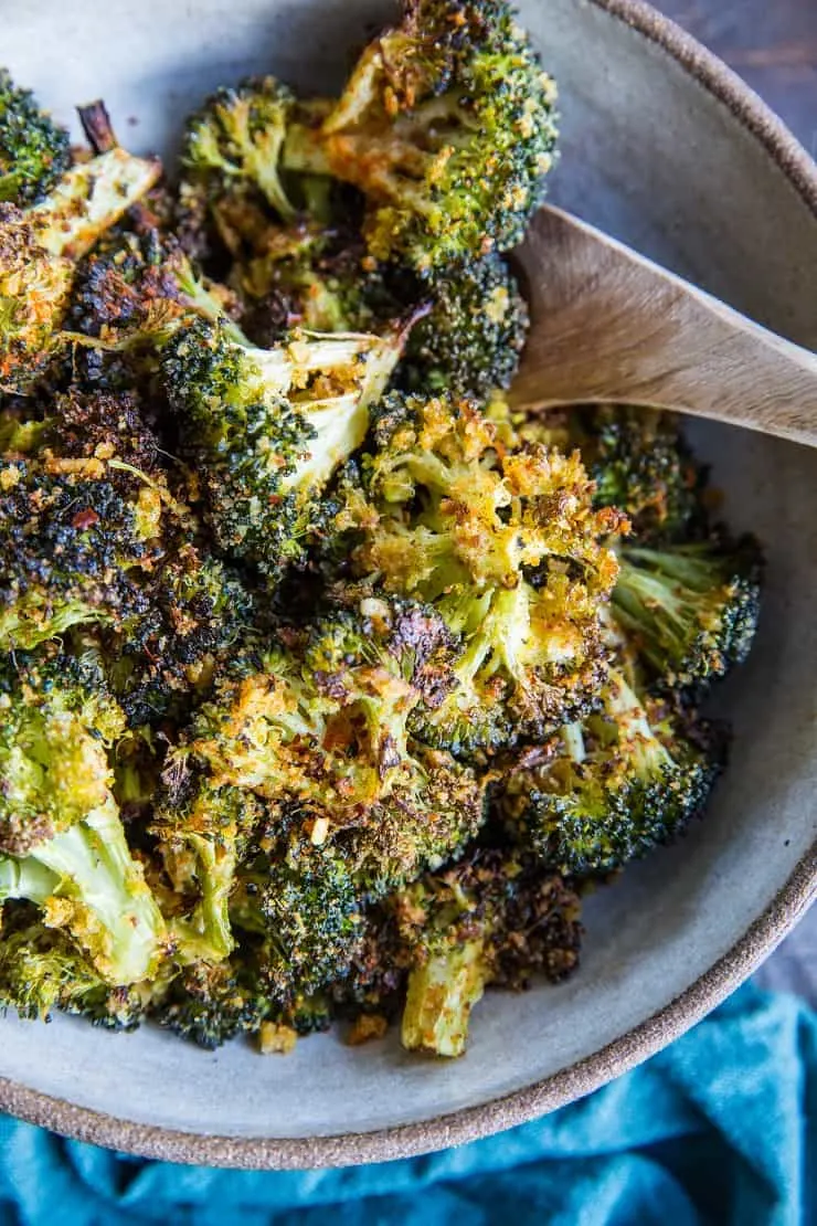 "Cheesy" Vegan Crispy Broccoli - an easy dairy-free roasted broccoli recipe that has a lovely cheesy flavor from nutritional yeast | TheRoastedRoot.com