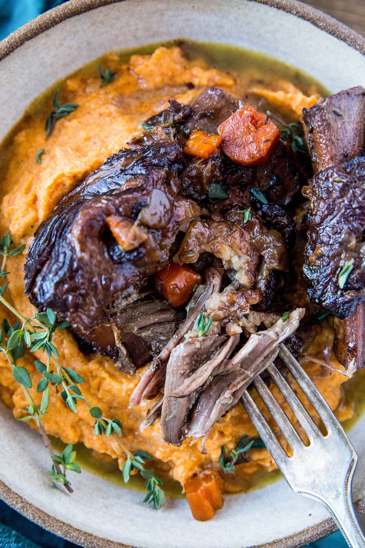 Instant Pot Short Ribs made paleo-friendly with tart cherry juice. Serve them atop mashed sweet potatoes for a delicious complete meal. | TheRoastedRoot.com #grainfree #glutenfree #healthyrecipe