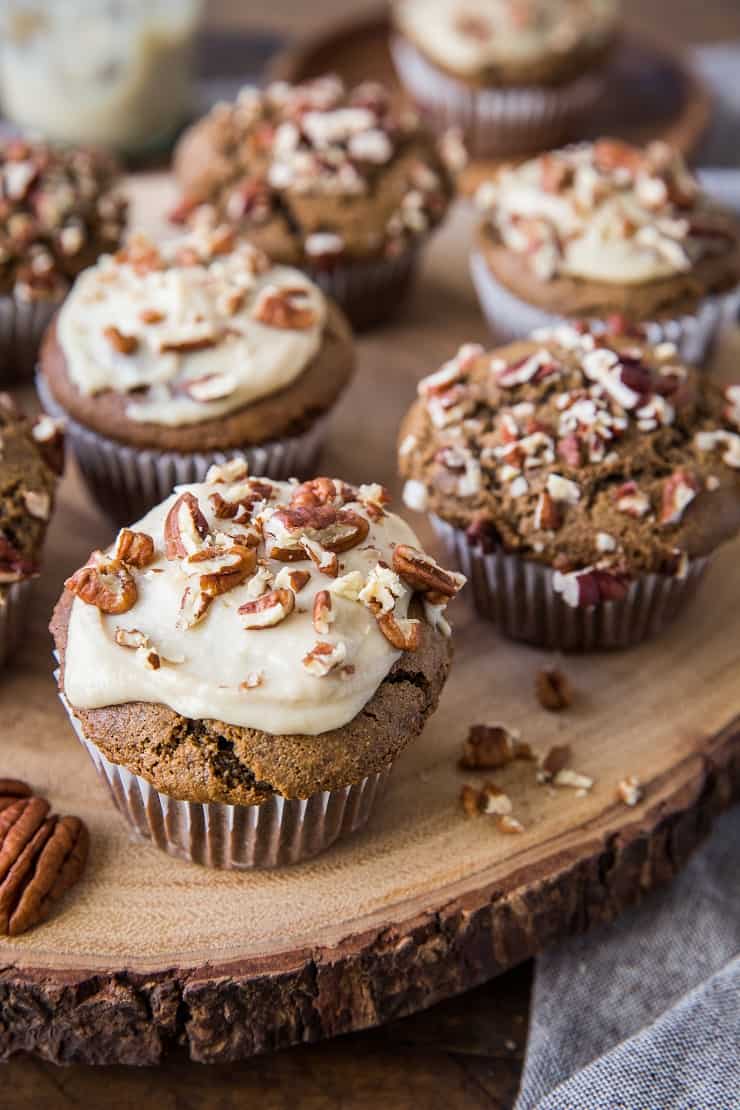 Wooden block with finished gingerbread muffins on top.