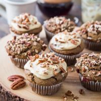 Wooden block with finished gingerbread muffins on top.